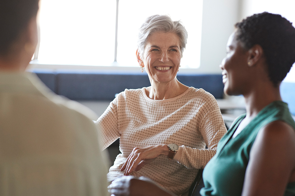 Three female employers having a happy chat with each other