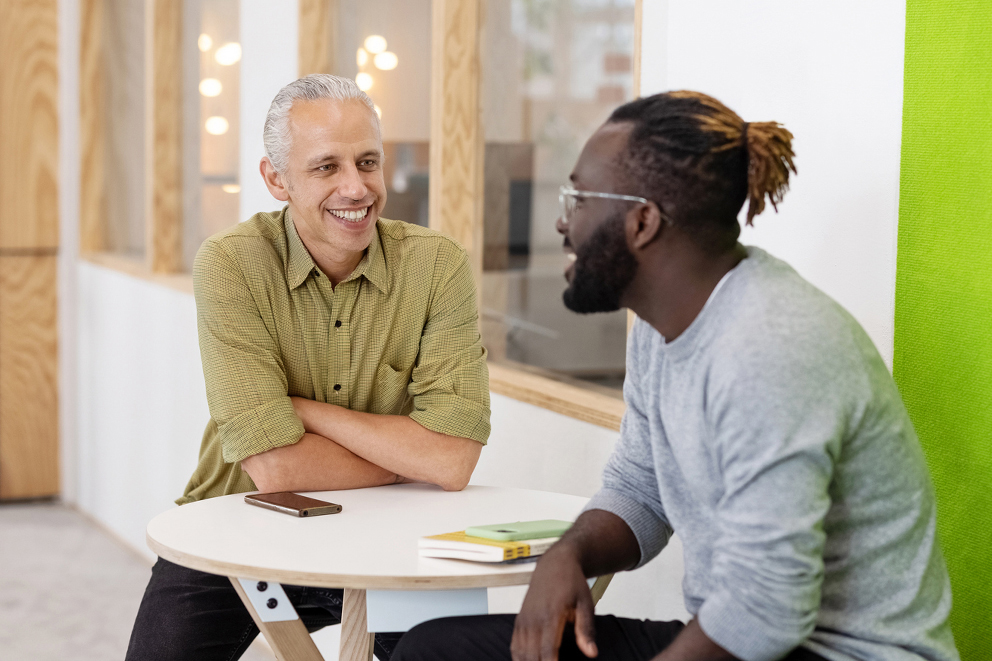 two employers smiling at desk